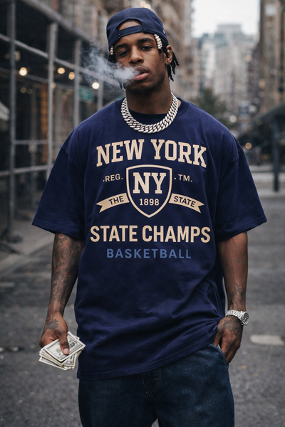 Man wearing a 'New York State Champs' t-shirt on a city street.