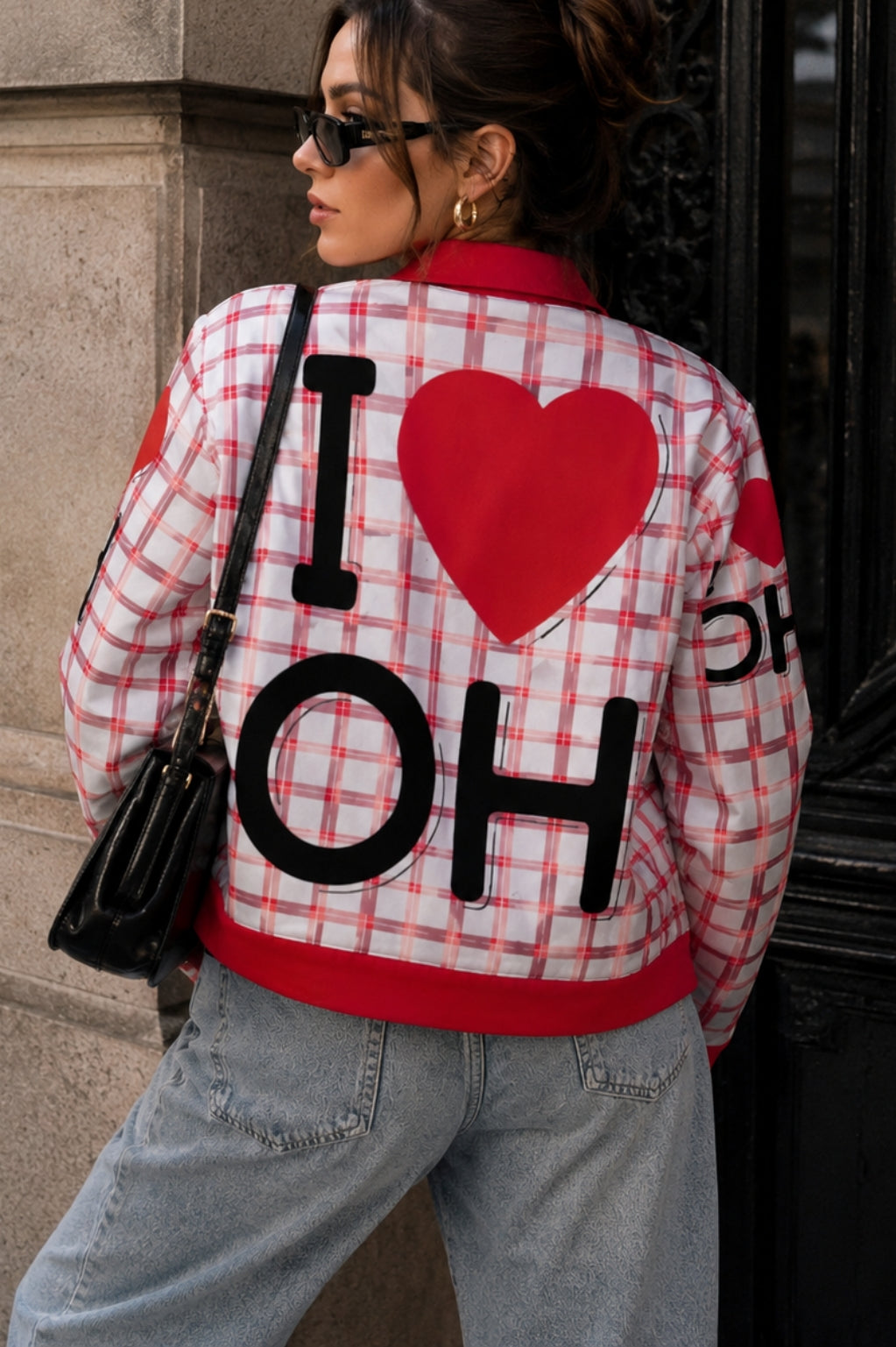 Person wearing a plaid jacket with 'I ❤️ OH' text and red heart design.