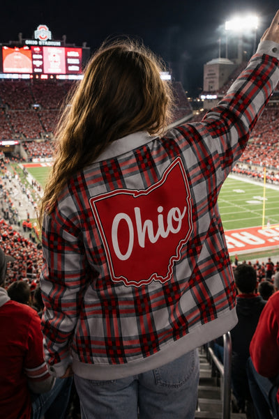 Person wearing a plaid jacket with 'Ohio' on it at a sports event.