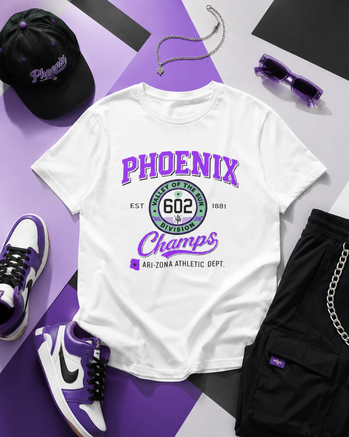 White t-shirt with 'Phoenix Champs' design, surrounded by black cap, sunglasses, black shorts, and purple sneakers on a purple and white background.