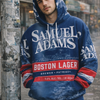 Person wearing a blue Samuel Adams hoodie in an urban setting