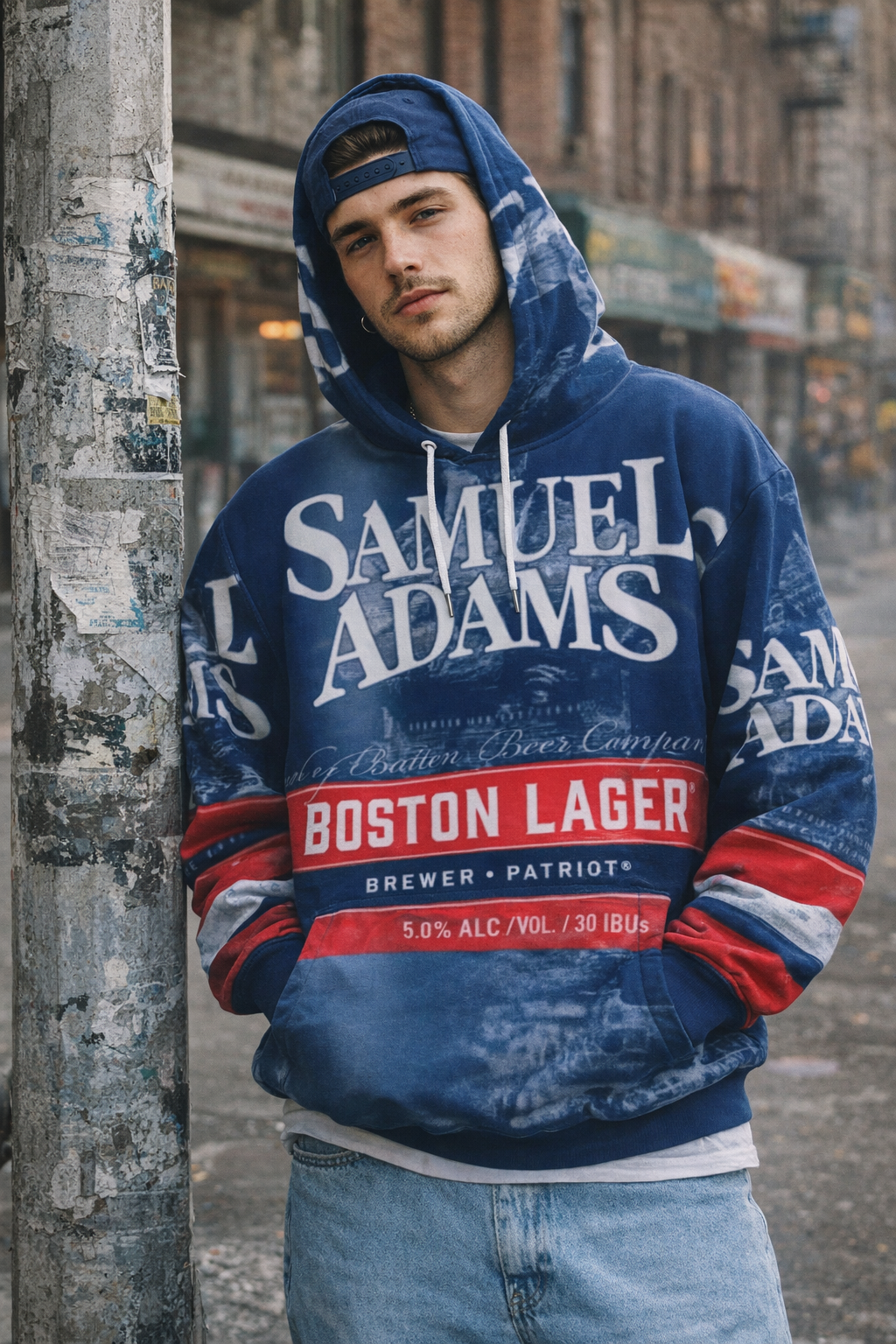 Person wearing a blue Samuel Adams hoodie in an urban setting