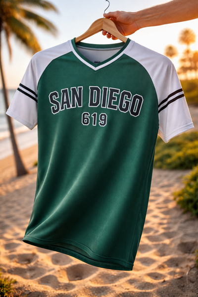 Green and white 'San Diego 619' jersey on a hanger with a beach background