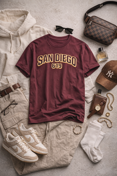 Maroon 'San Diego 619' t-shirt with casual clothing and accessories on a light surface