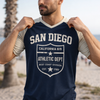 Man wearing a navy blue 'San Diego' t-shirt on a beach