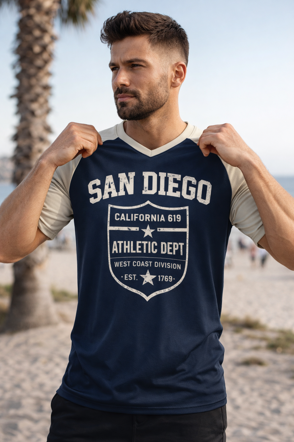 Man wearing a navy blue 'San Diego' t-shirt on a beach