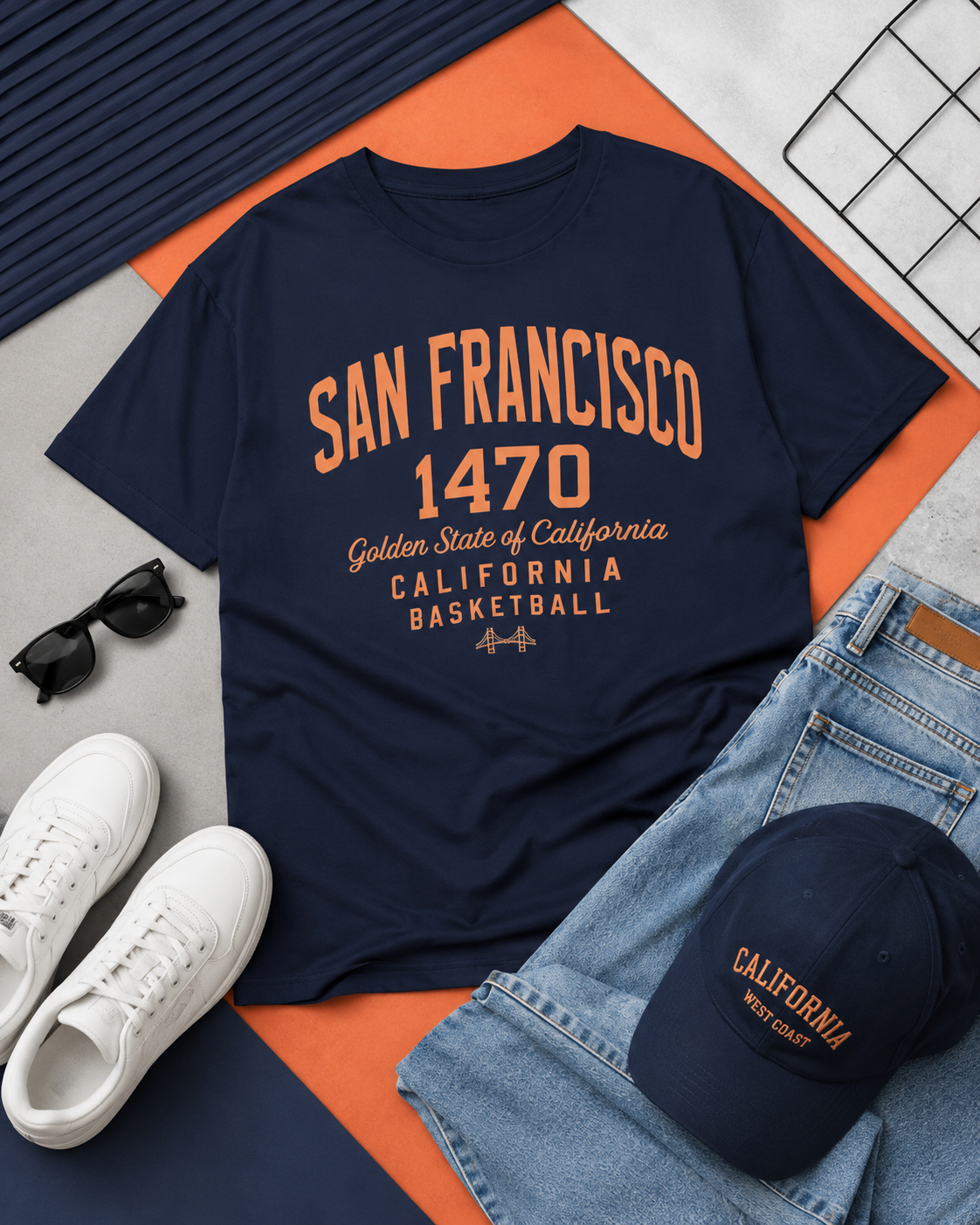 Navy t-shirt with 'San Francisco 1470' text, sunglasses, white sneakers, jeans, and a cap on a multicolored surface.
