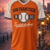 Orange and white baseball jersey with 'San Francisco Baseball Academy' text against a cityscape background.