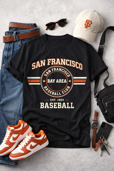 Black t-shirt with 'San Francisco Bay Area Baseball Club' design, paired with jeans, sneakers, a cap, and accessories on a light gray surface.