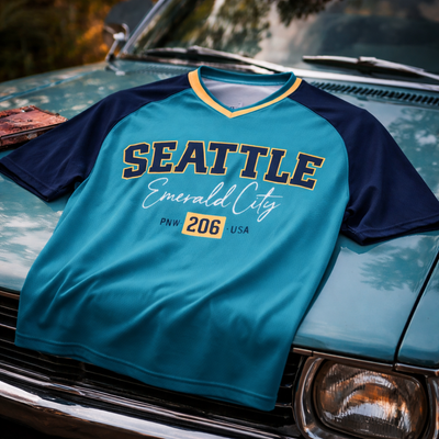 Blue and navy shirt with 'Seattle Emerald City' text on a vintage car