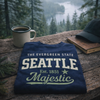 Navy blue sweatshirt with 'Seattle' text on a wooden surface with a scenic background