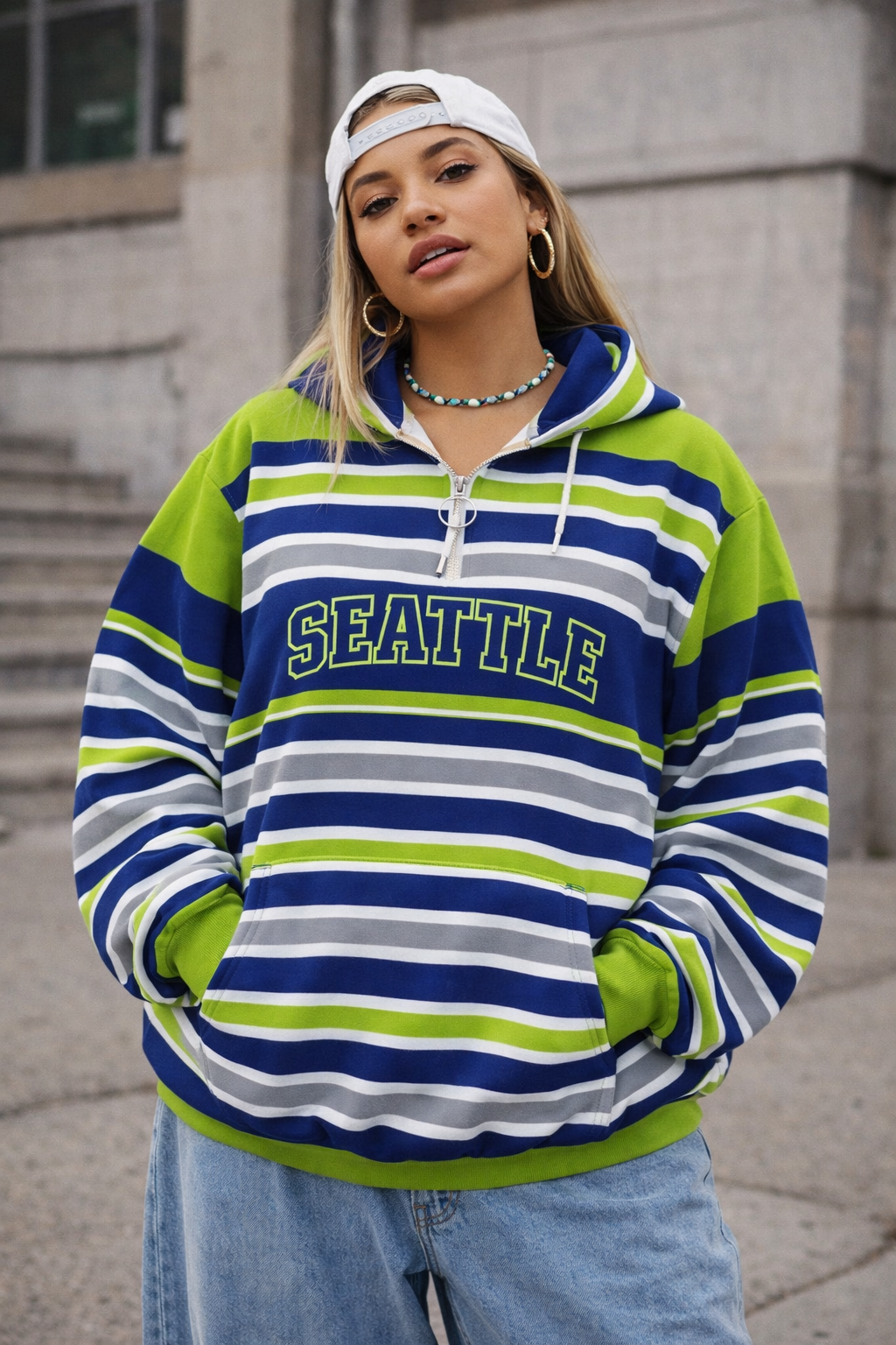 Person wearing a striped hoodie with 'Seattle' text, standing outdoors.