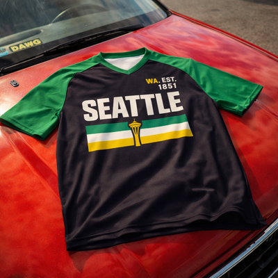 Black t-shirt with 'Seattle' and Space Needle graphic on a red car hood