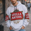 Person wearing a Stella Artois hoodie on a city street