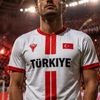 Person wearing a sports jersey with 'Türkiye' printed on it, standing in a stadium.