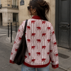 Person wearing a red and white patterned shirt on a city street.
