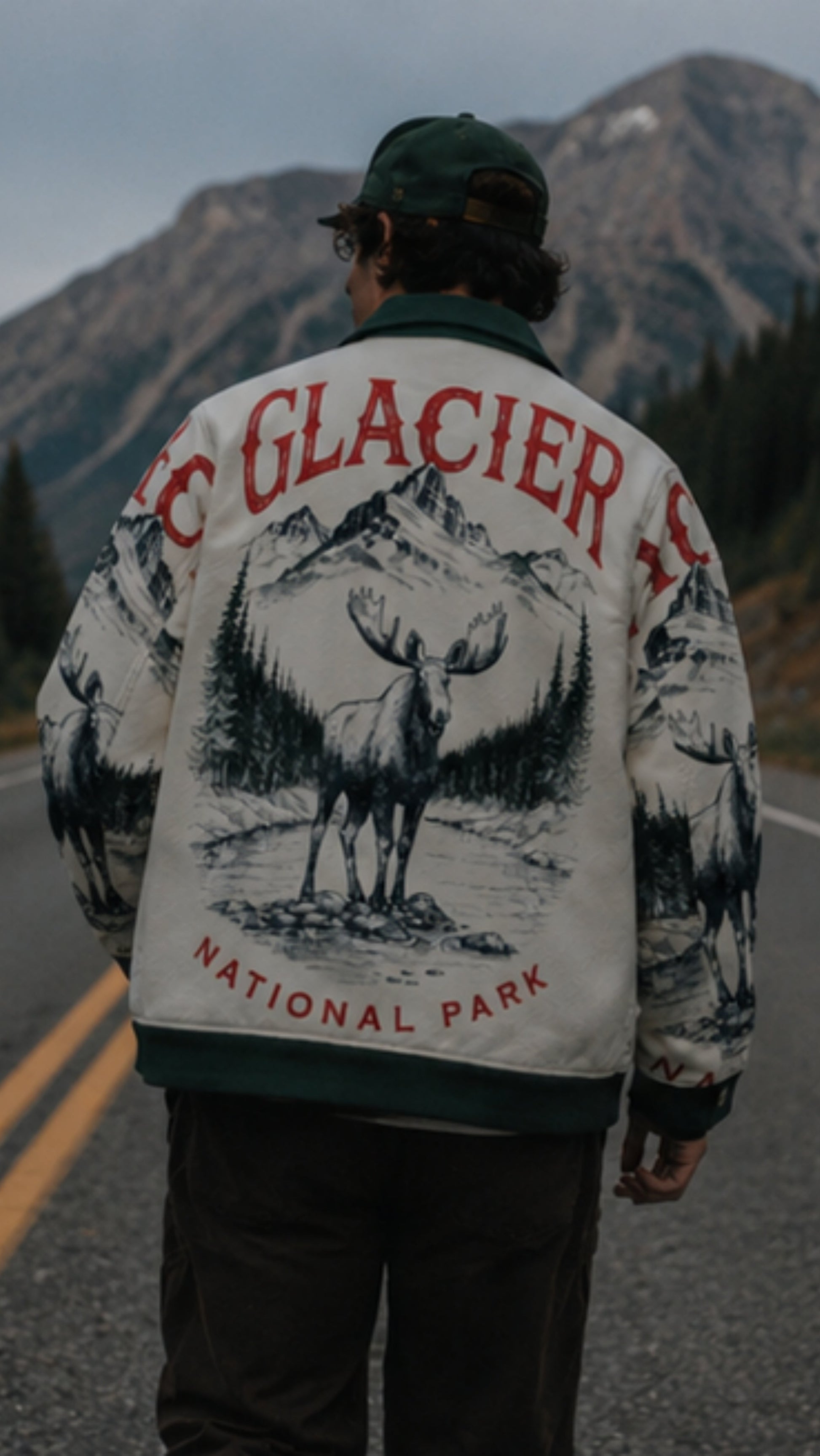 Person wearing a jacket with Glacier National Park design on a mountain road