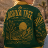 Person wearing a 'Joshua Tree National Park' jacket in a desert setting